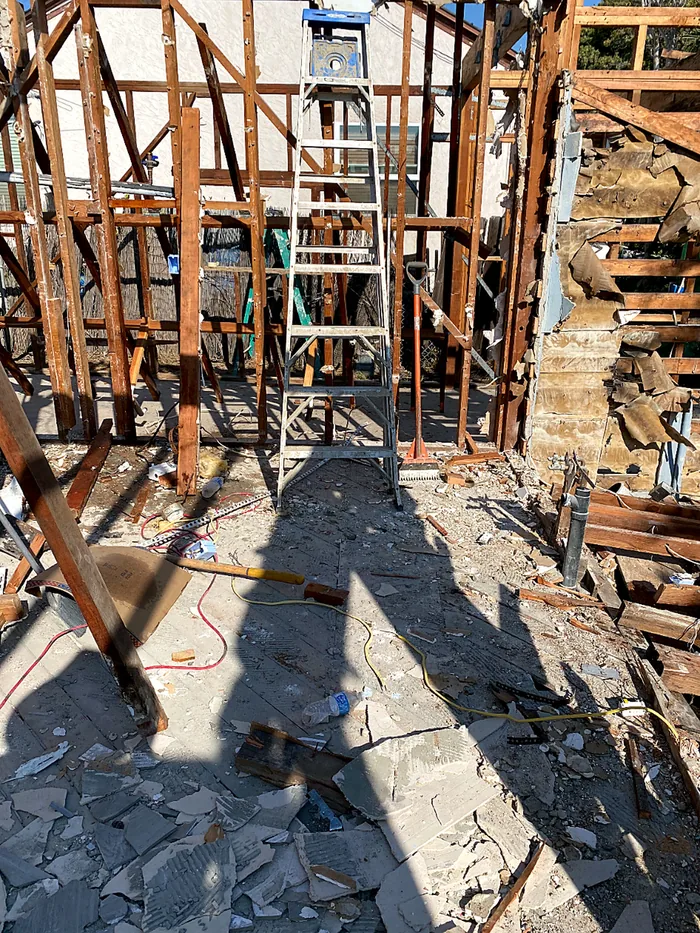 Open wood wall framing during a structural rebuild